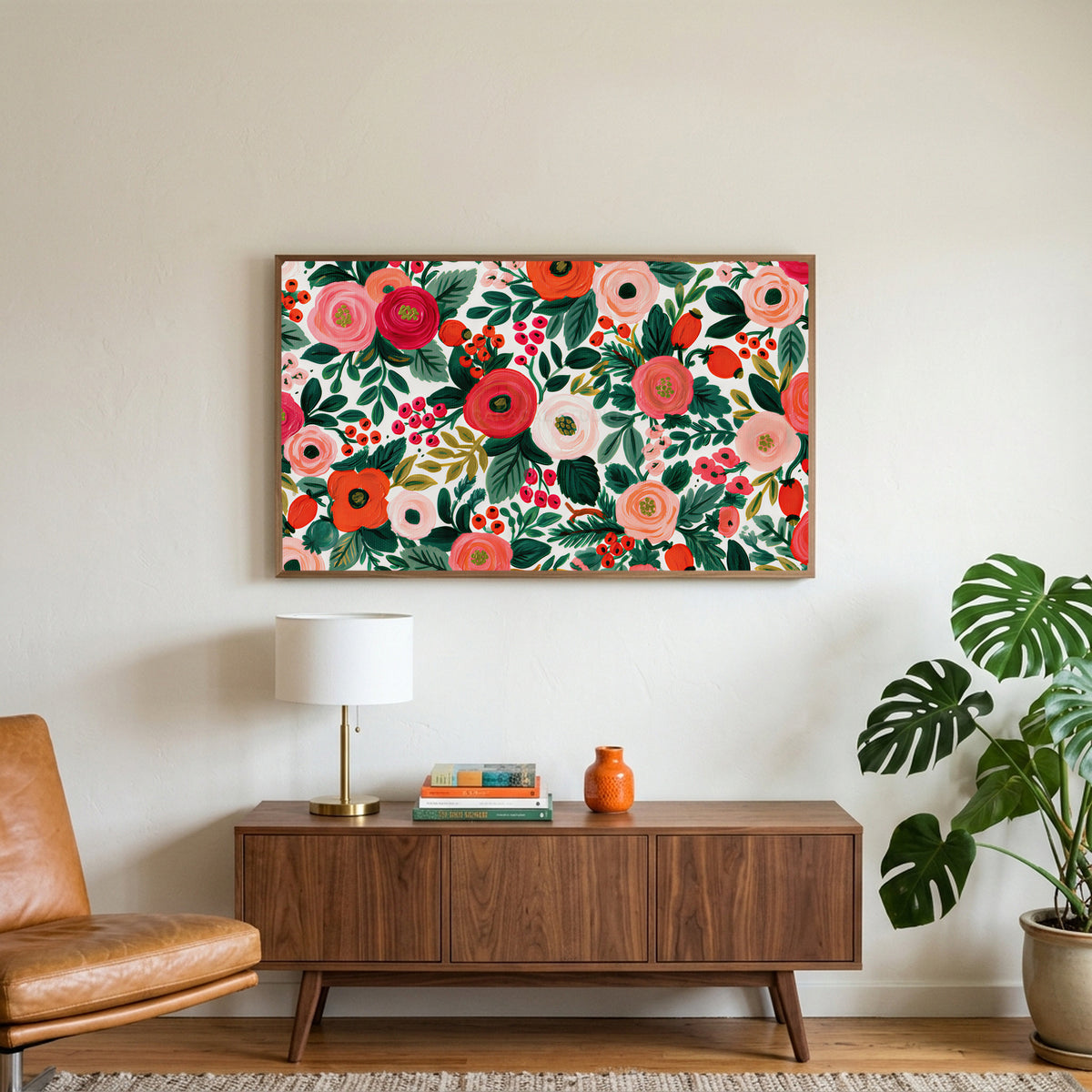 Painted roses and berries art on a TV above a walnut credenza with a brass lamp and a monstera plant