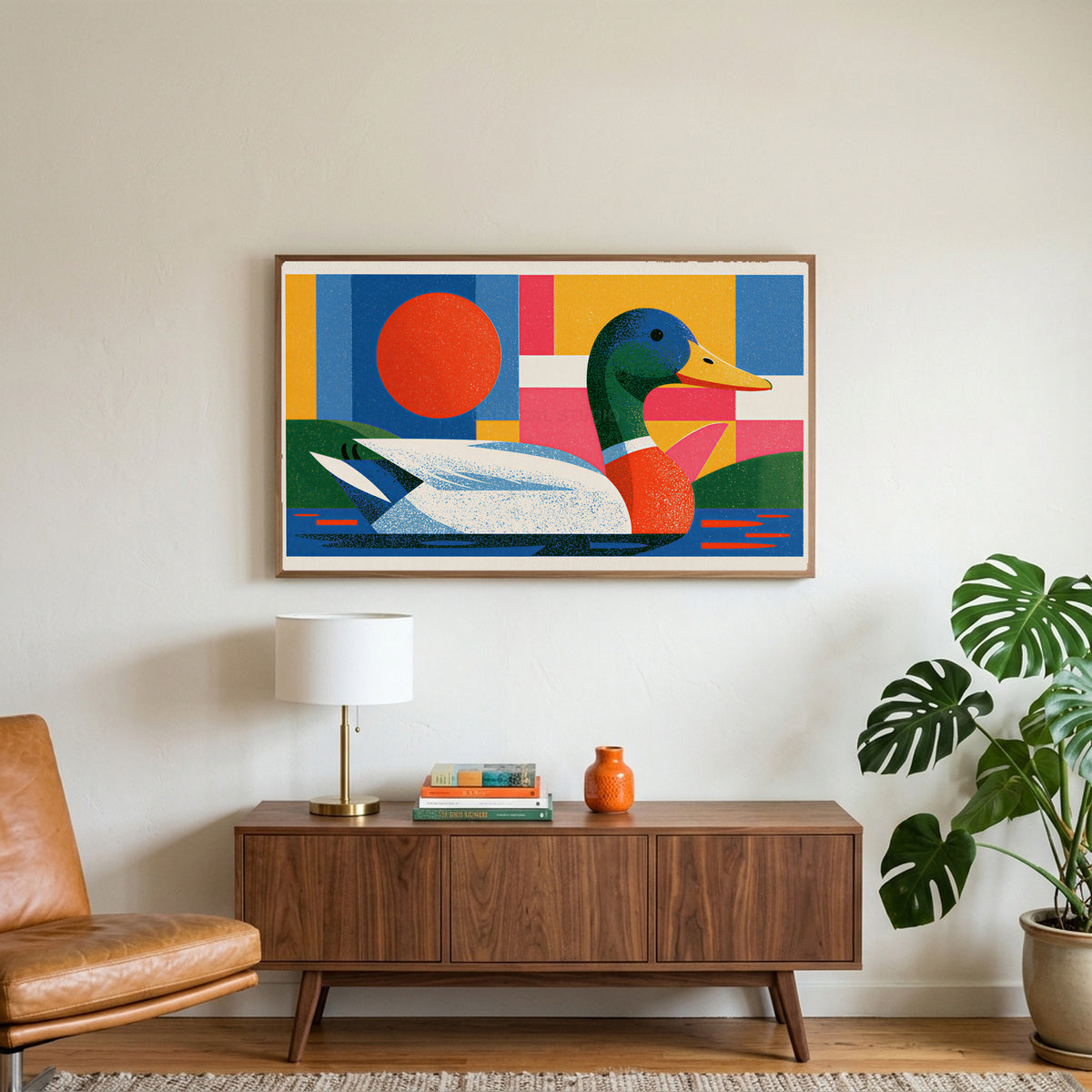Colorful geometric mallard art on a TV above a walnut credenza with a brass lamp and a monstera plant