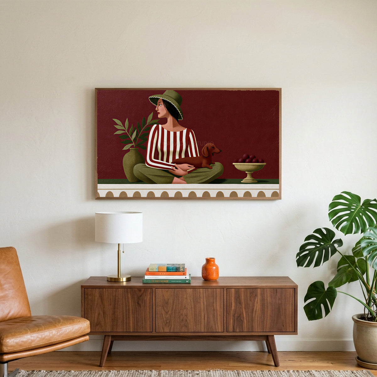 Woman with a dachshund art on a TV above a walnut credenza with a brass lamp and a monstera plant