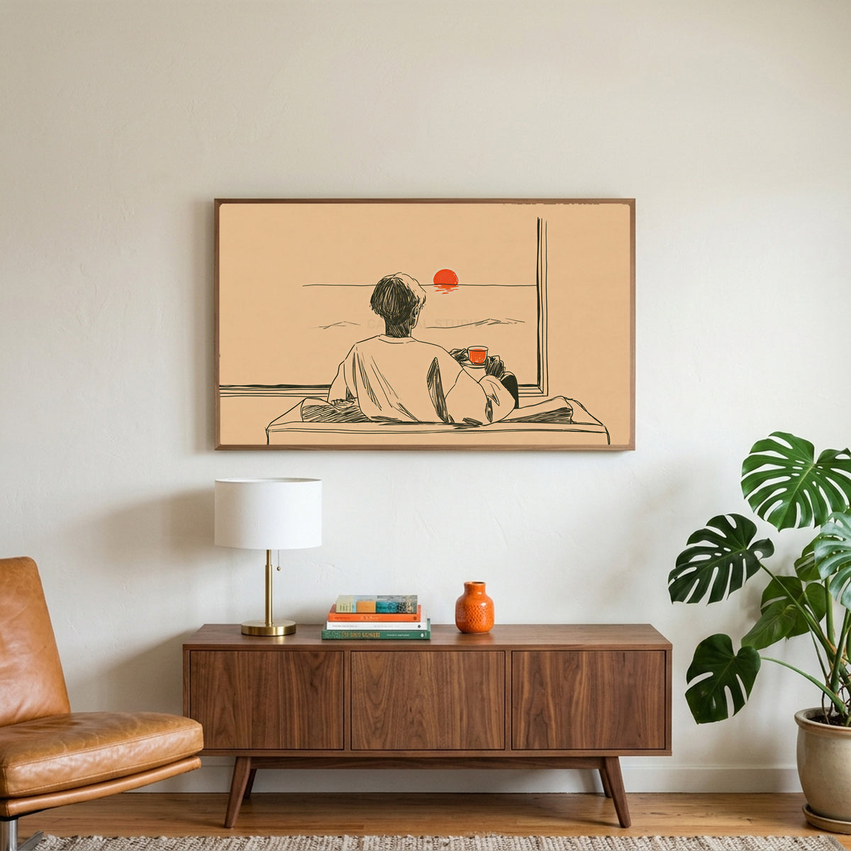 Sunset tea art on a TV above a walnut credenza with a brass lamp and a monstera plant