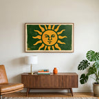 Woodblock sun art on a TV above a walnut credenza with a brass lamp and a monstera plant