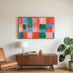 Painted checks art on a TV above a walnut credenza with a brass lamp and a monstera plant