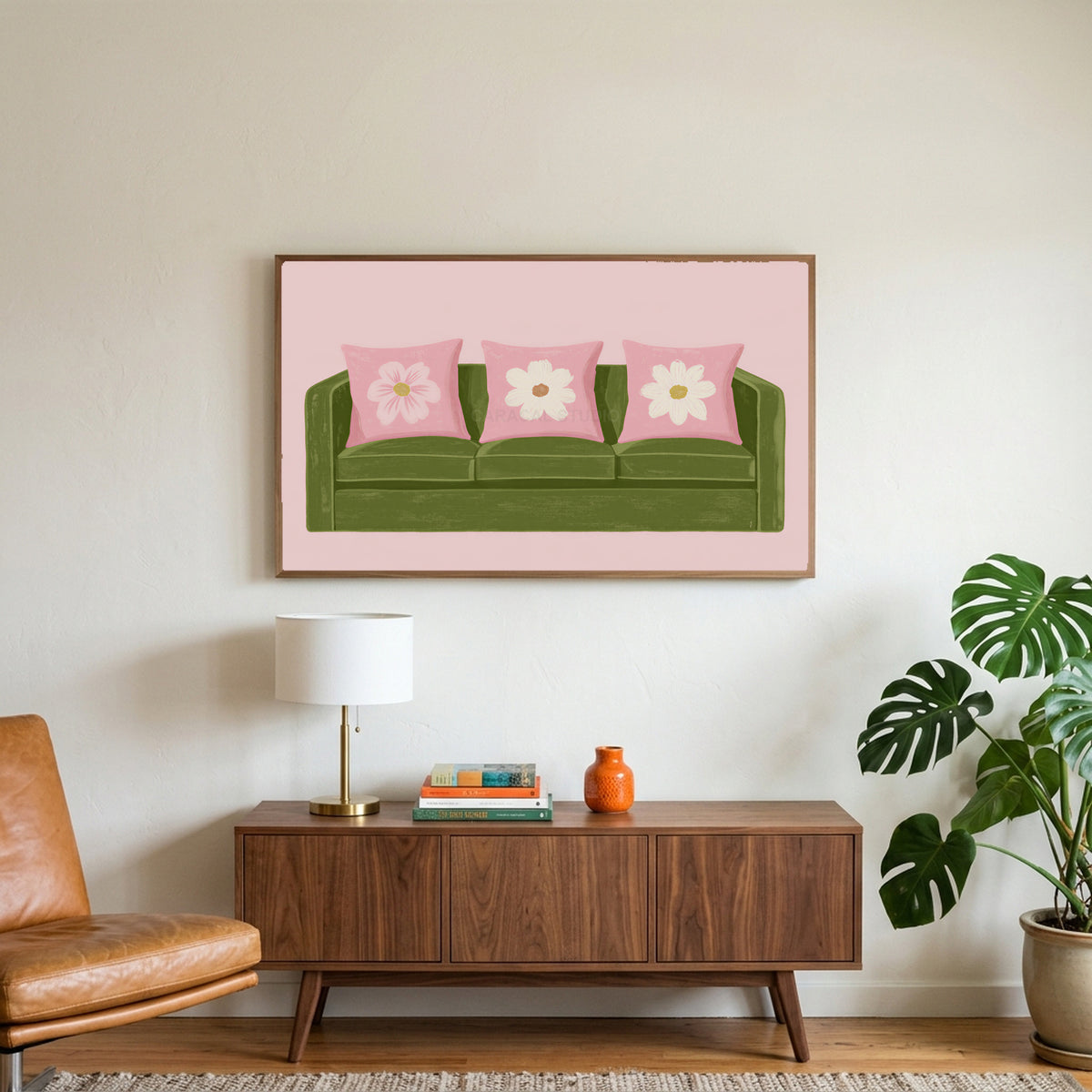 Green sofa art on a TV above a walnut credenza with a brass lamp and a monstera plant