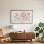 Rose line drawing art on a TV above a walnut credenza with a brass lamp and a monstera plant