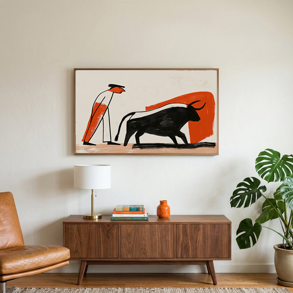 Matador and bull art on a TV above a walnut credenza with a brass lamp and a monstera plant