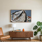 Starry veil woman art on a TV above a walnut credenza with a brass lamp and a monstera plant