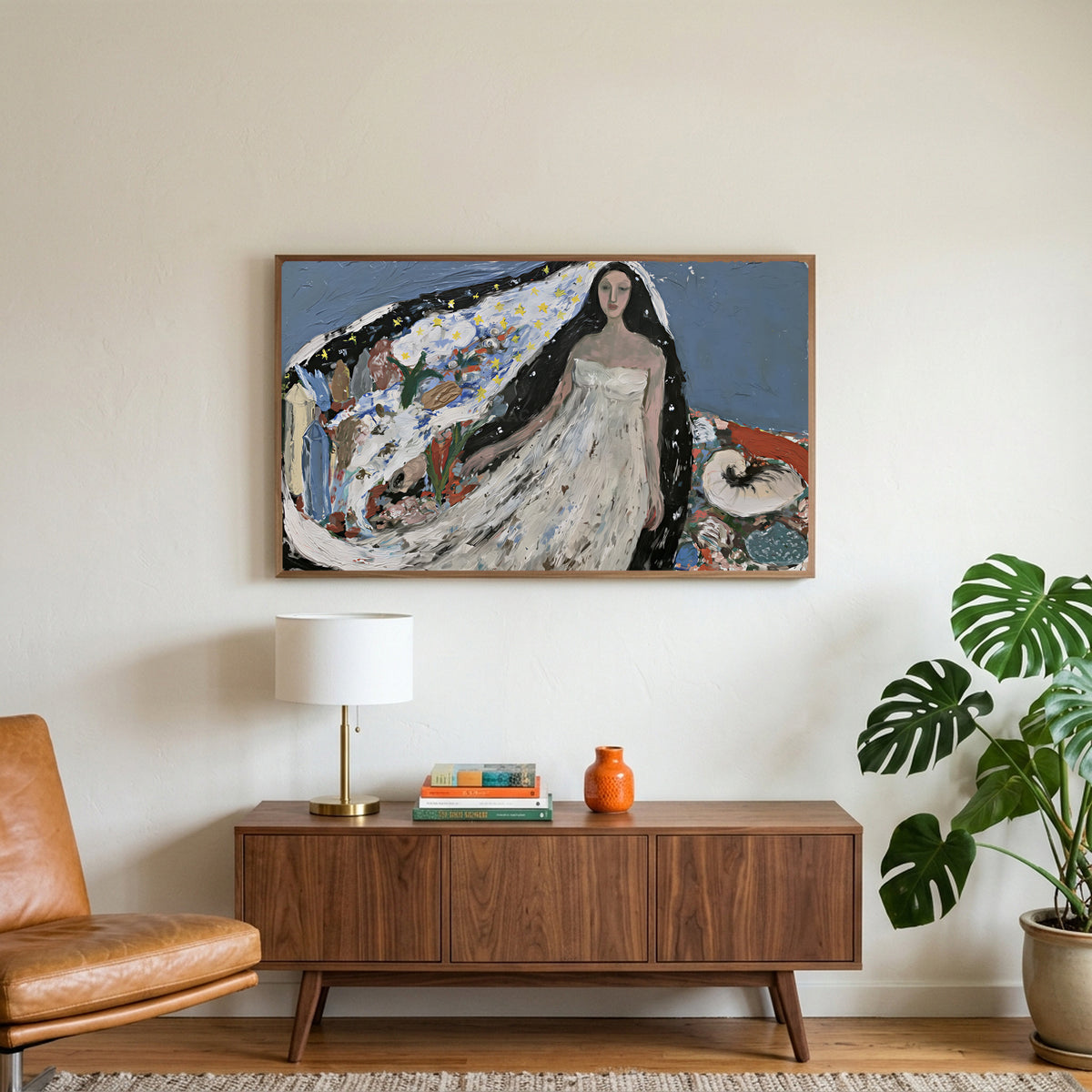 Starry veil woman art on a TV above a walnut credenza with a brass lamp and a monstera plant
