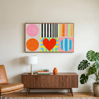 Colorful shapes and heart art on a TV above a walnut credenza with a brass lamp and a monstera plant