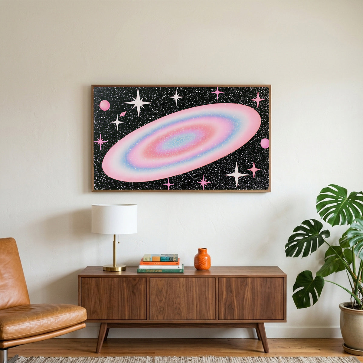Pastel galaxy art on a TV above a walnut credenza with a brass lamp and a monstera plant