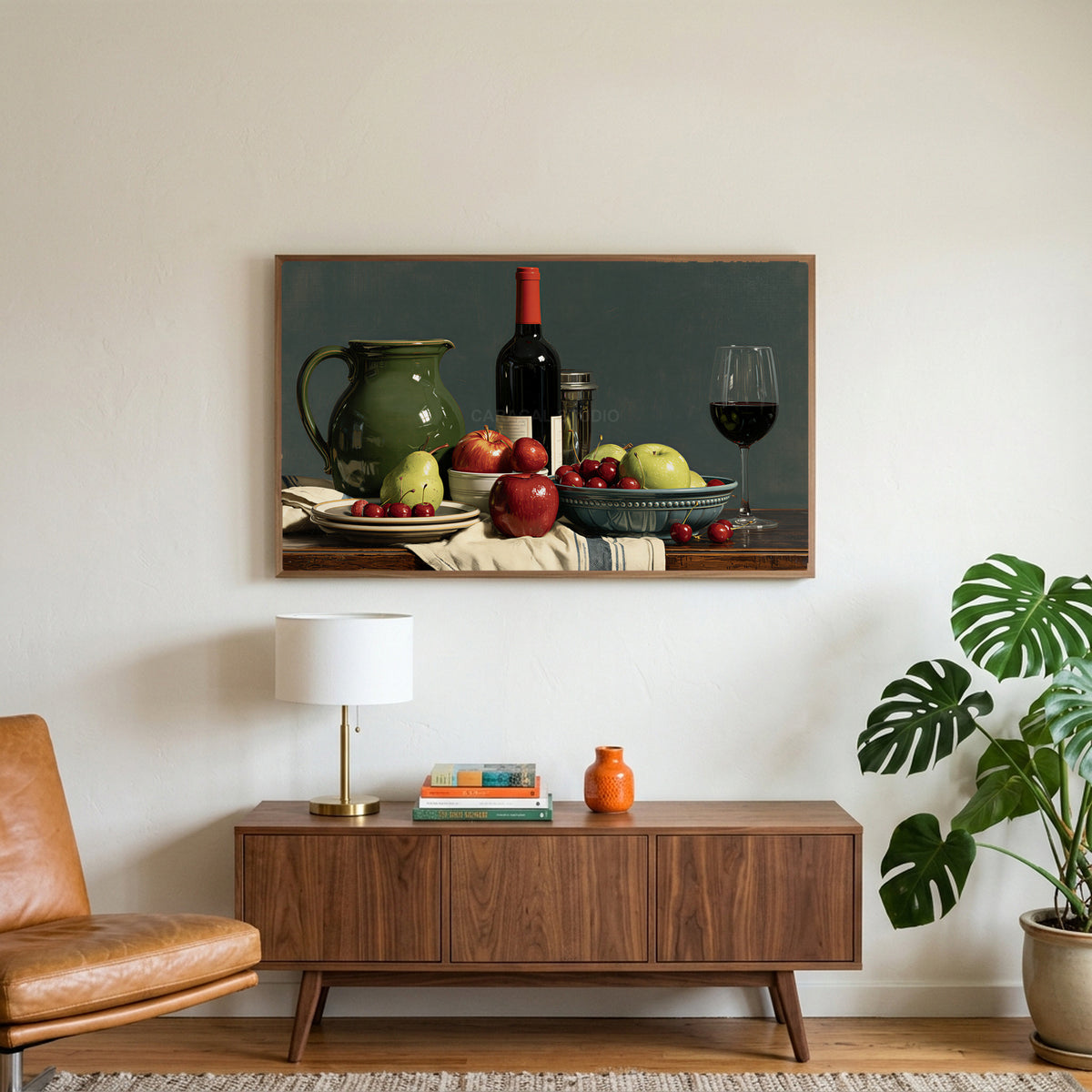 Wine and fruit still life art on a TV above a walnut credenza with a brass lamp and a monstera plant