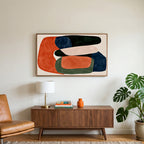 Abstract organic shapes art on a TV above a walnut credenza with a brass lamp and a monstera plant