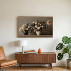 Roses and hydrangeas still life art on a TV above a walnut credenza with a brass lamp and a monstera plant