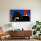 Man in red fez with horse art on a TV above a walnut credenza with a brass lamp and a monstera plant