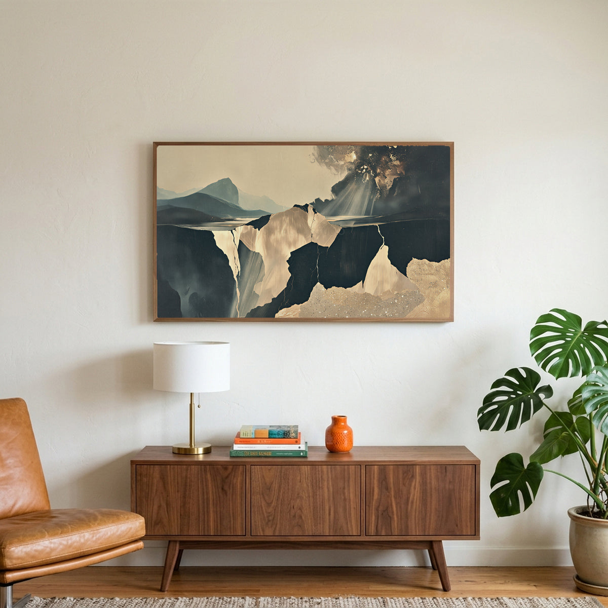 Moody abstract cliffs art on a TV above a walnut credenza with a brass lamp and a monstera plant
