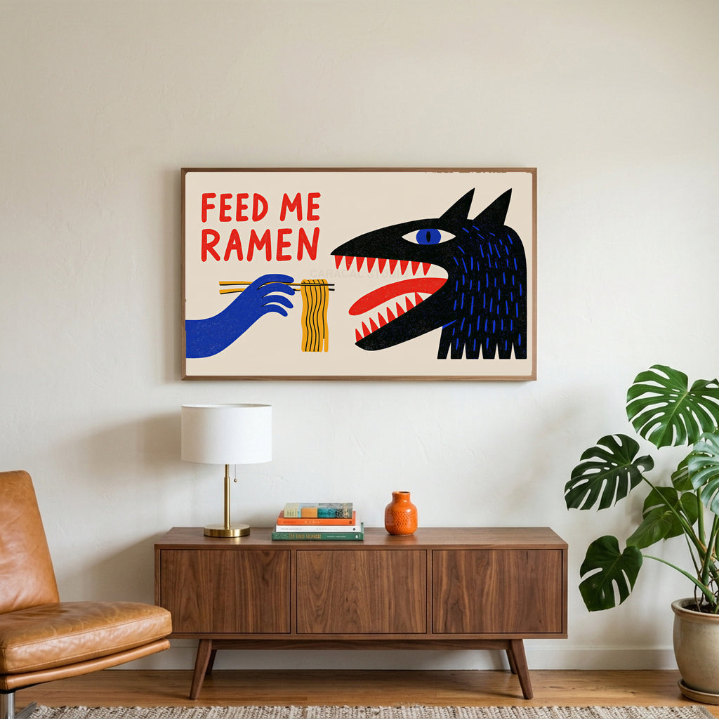 Feed Me Ramen art on a TV above a walnut credenza with a brass lamp and a monstera plant