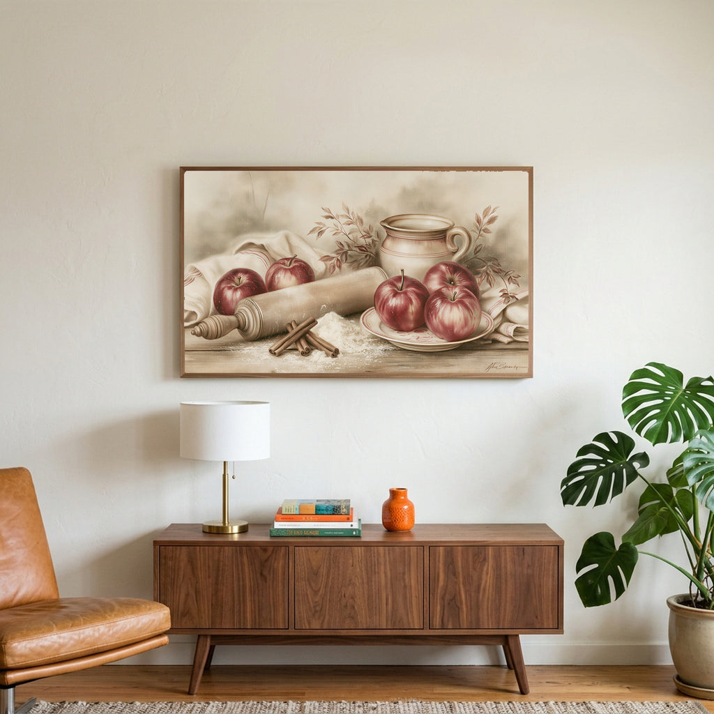 Farmhouse apples art on a TV above a walnut credenza with a brass lamp and a monstera plant