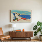 Red car on a coastal road art on a TV above a walnut credenza with a brass lamp and a monstera plant