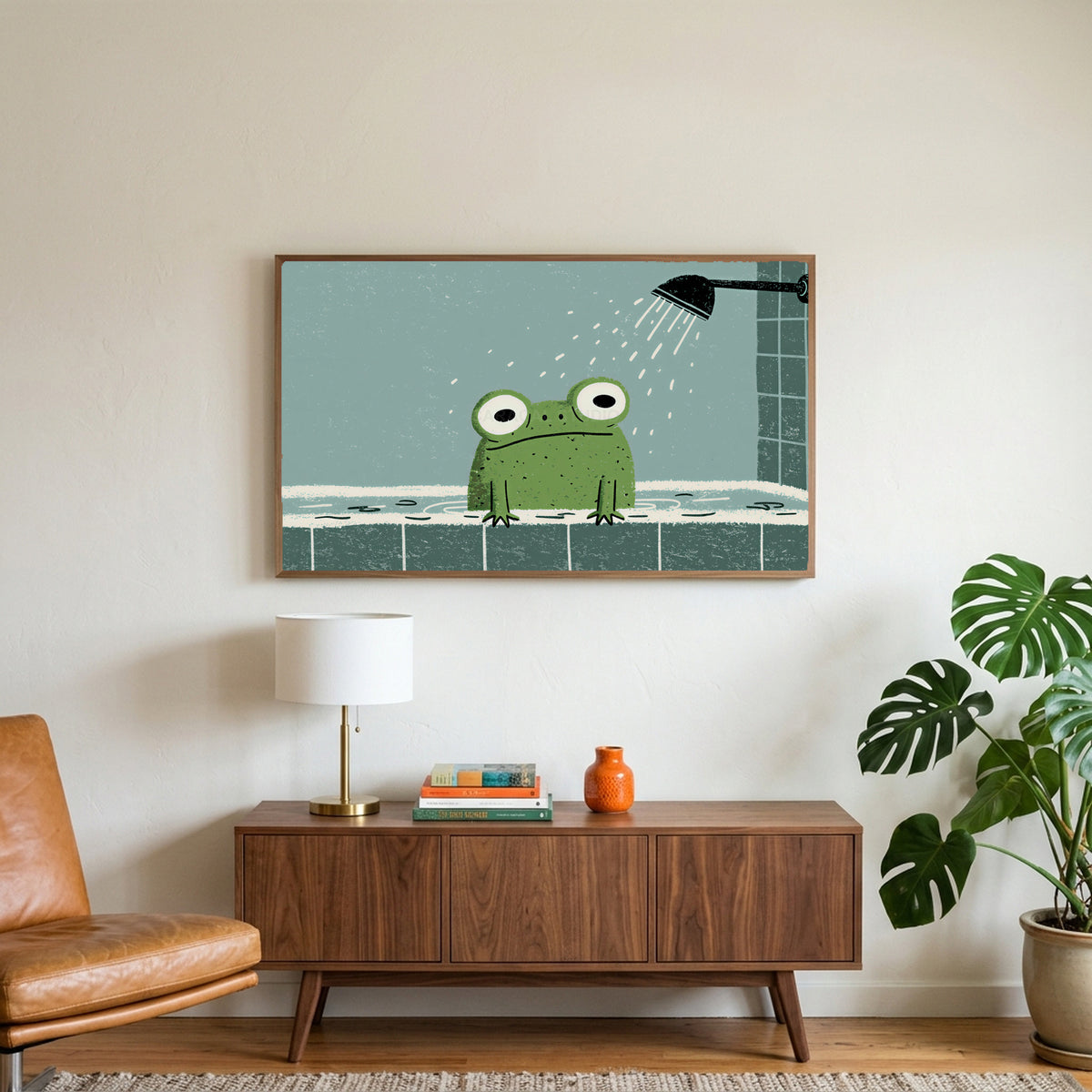 Frog in the shower art on a TV above a walnut credenza with a brass lamp and a monstera plant