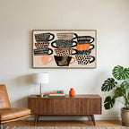 Stacked teacups art on a TV above a walnut credenza with a brass lamp and a monstera plant