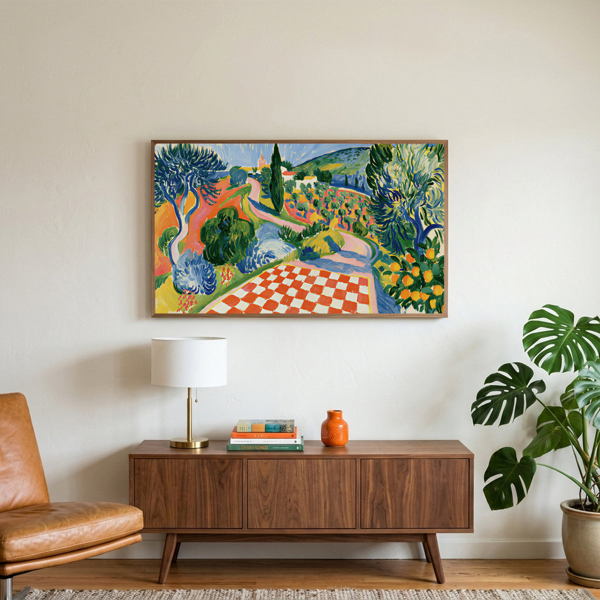 Italian countryside art on a TV above a walnut credenza with a brass lamp and a monstera plant