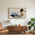 Patchwork duck art on a TV above a walnut credenza with a brass lamp and a monstera plant
