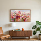 Pink wildflower meadow art on a TV above a walnut credenza with a brass lamp and a monstera plant