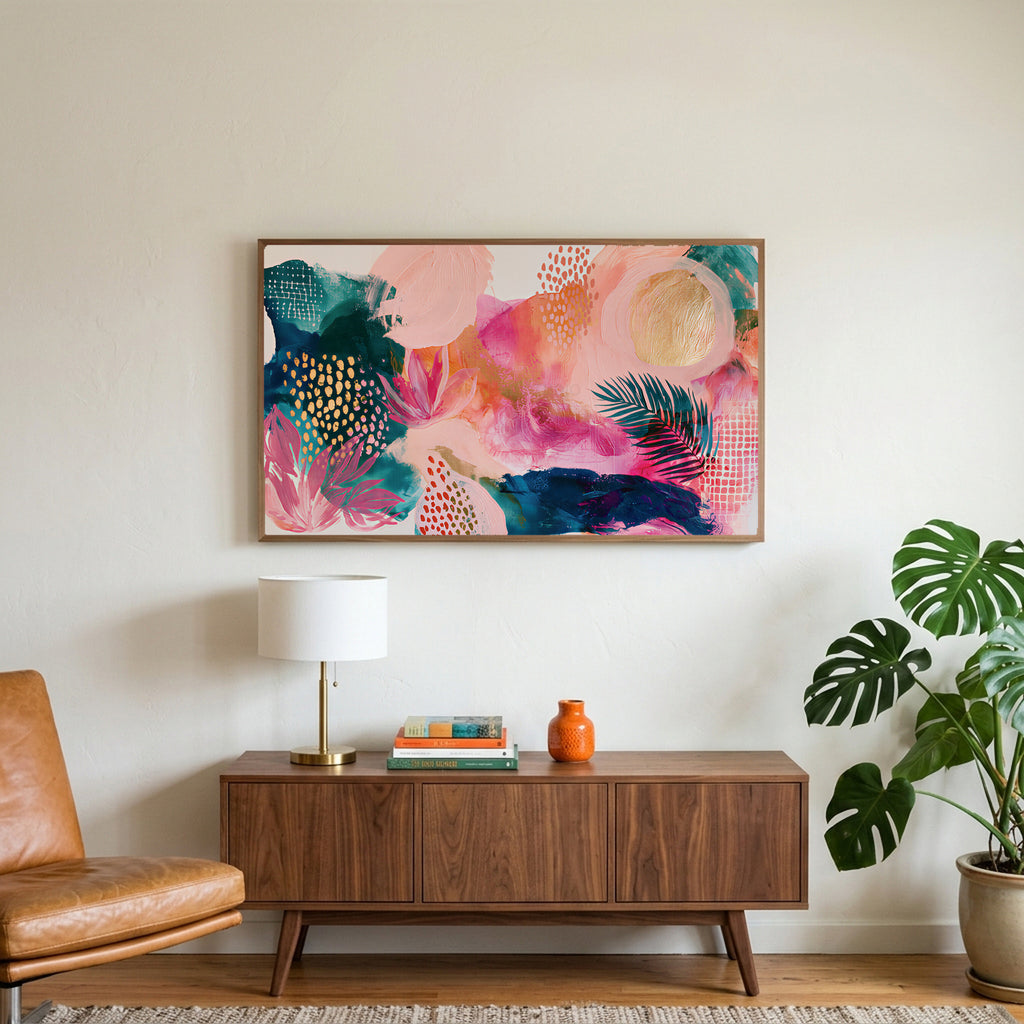 Tropical abstract art on a TV above a walnut credenza with a brass lamp and a monstera plant
