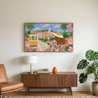 Lisbon tram art on a TV above a walnut credenza with a brass lamp and a monstera plant