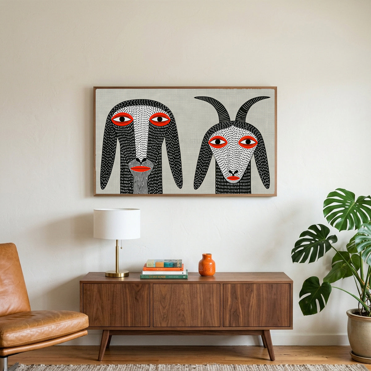 Folk art goats art on a TV above a walnut credenza with a brass lamp and a monstera plant