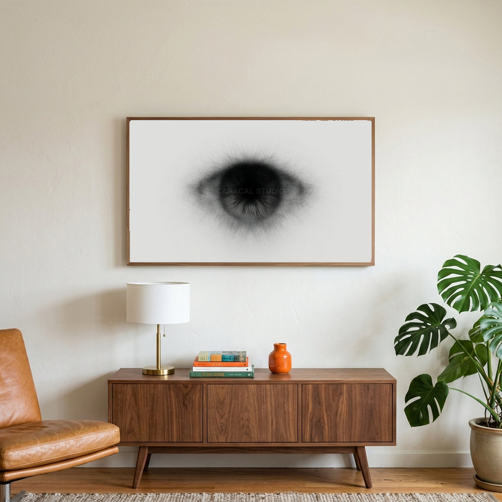 Black and white eye art on a TV above a walnut credenza with a brass lamp and a monstera plant
