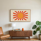 Retro sunburst art on a TV above a walnut credenza with a brass lamp and a monstera plant