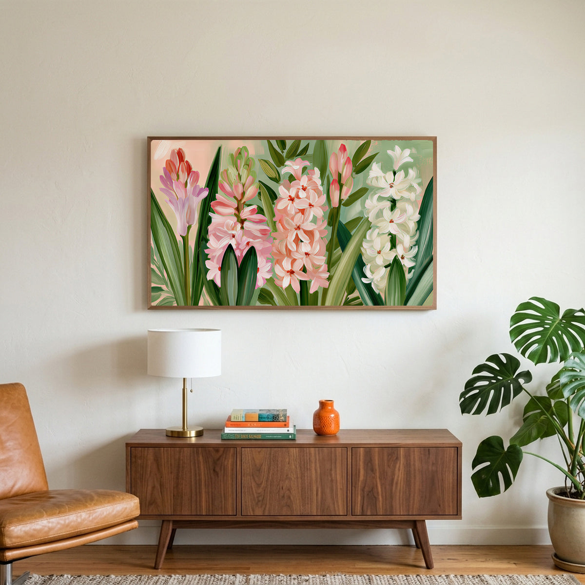 Spring hyacinths art on a TV above a walnut credenza with a brass lamp and a monstera plant