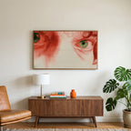 Red pencil eyes art on a TV above a walnut credenza with a brass lamp and a monstera plant