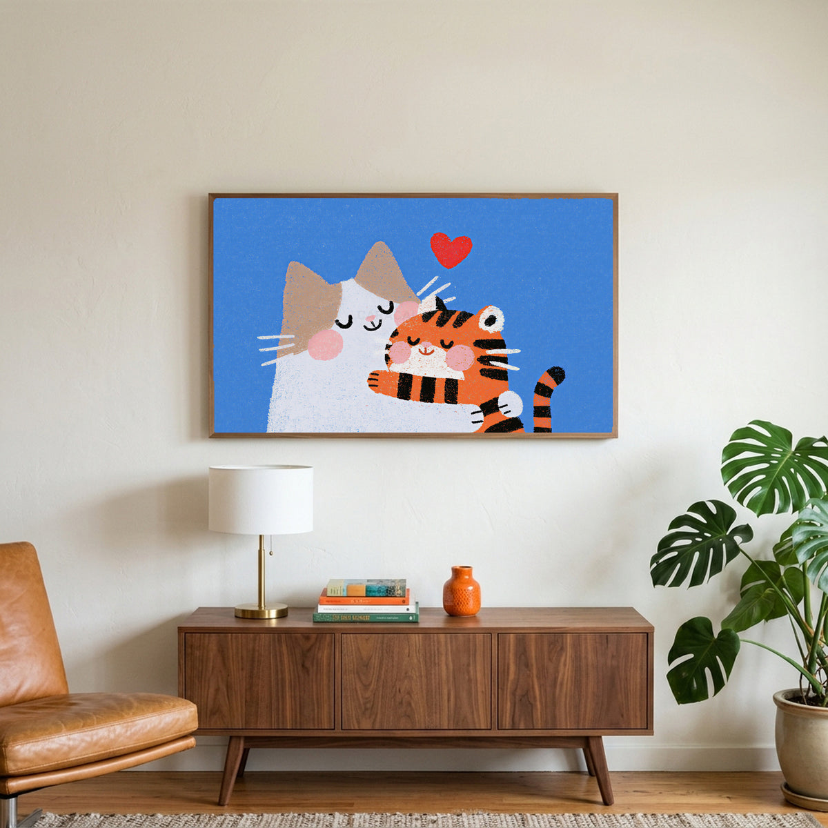 Two cats with a heart art on a TV above a walnut credenza with a brass lamp and a monstera plant