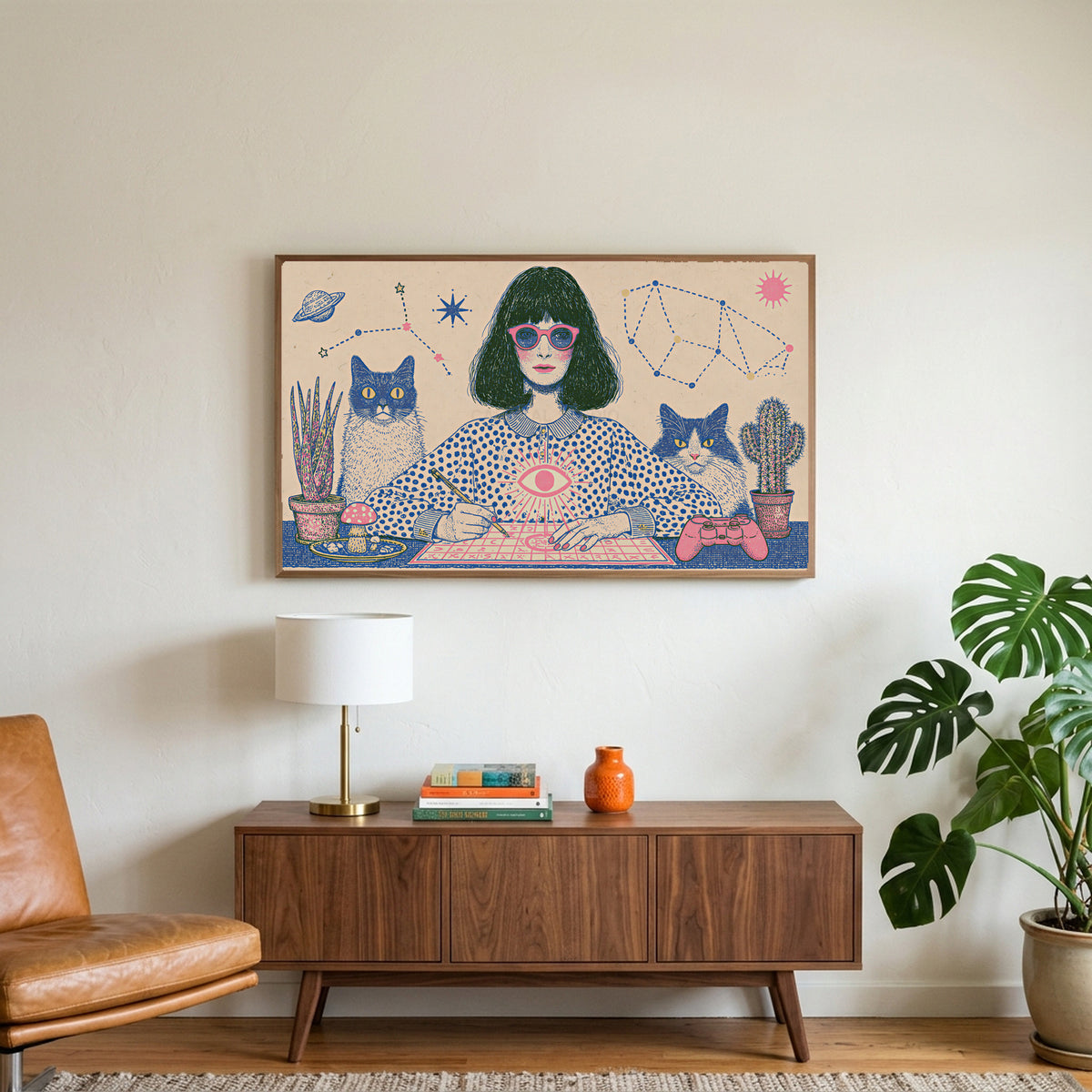 Astrology and cats art on a TV above a walnut credenza with a brass lamp and a monstera plant