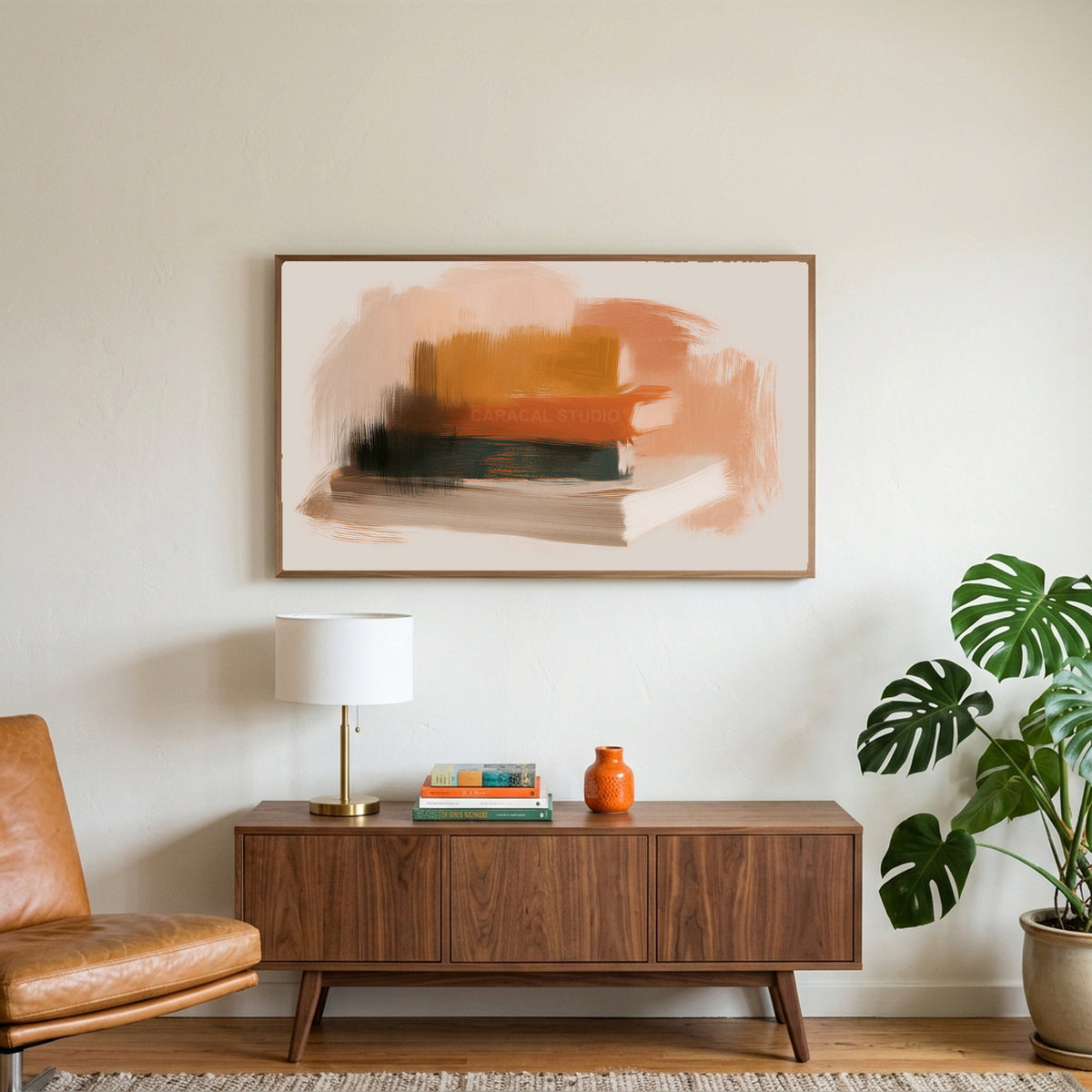 Book stack art on a TV above a walnut credenza with a brass lamp and a monstera plant