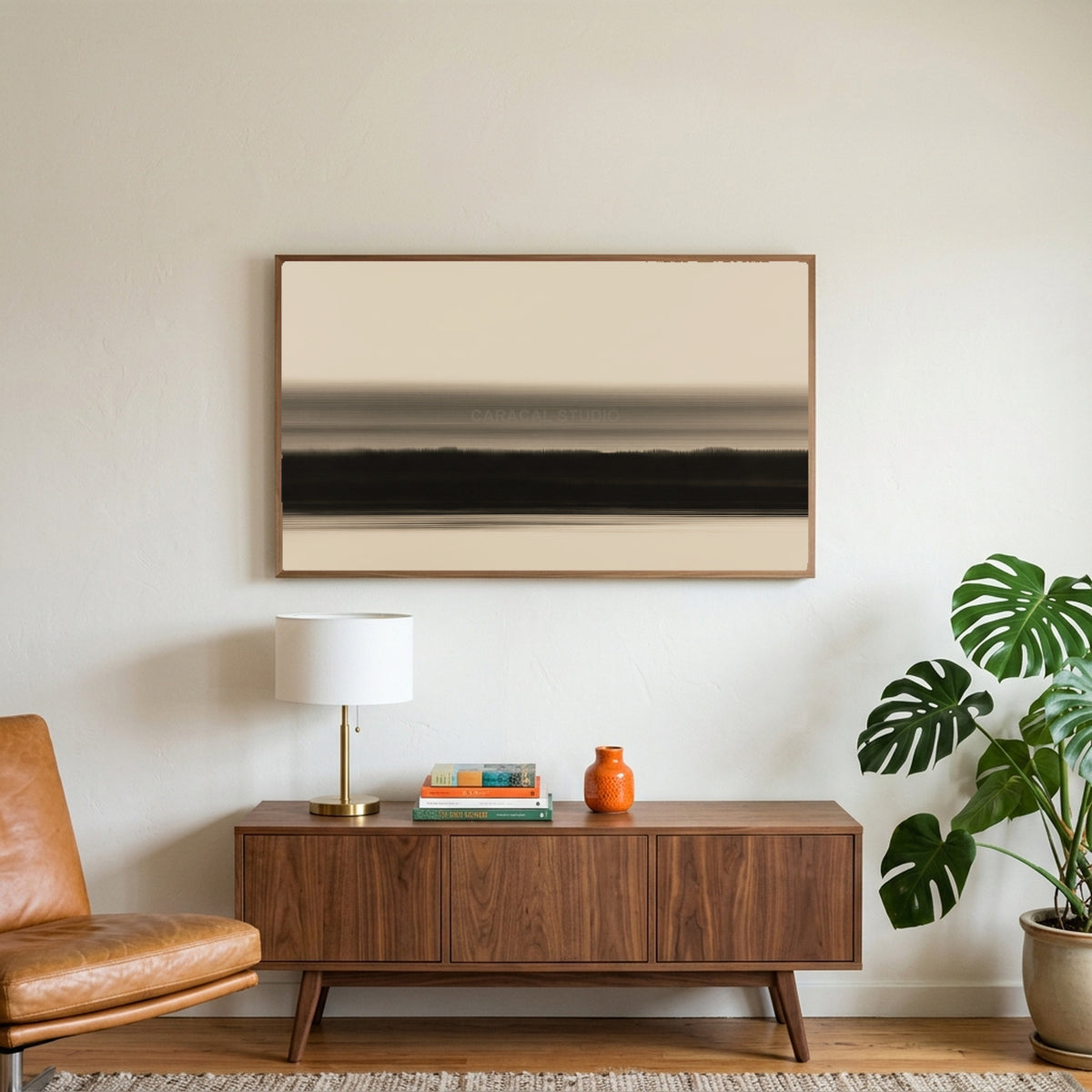 Ink wash horizon art on a TV above a walnut credenza with a brass lamp and a monstera plant