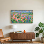 Poppy field art on a TV above a walnut credenza with a brass lamp and a monstera plant