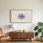 Mystic eye art on a TV above a walnut credenza with a brass lamp and a monstera plant
