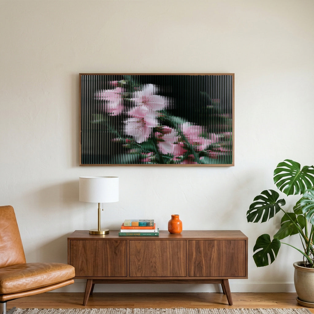Fluted glass blossom art on a TV above a walnut credenza with a brass lamp and a monstera plant