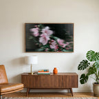 Fluted glass blossom art on a TV above a walnut credenza with a brass lamp and a monstera plant