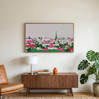 Paris skyline art on a TV above a walnut credenza with a brass lamp and a monstera plant