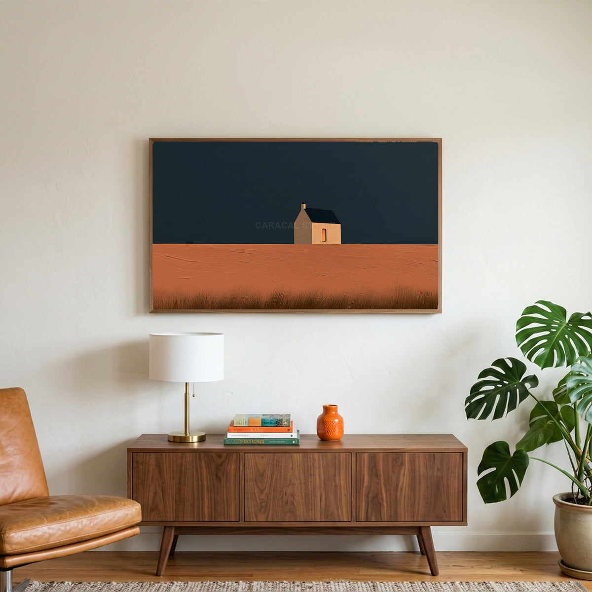 Lone cottage art on a TV above a walnut credenza with a brass lamp and a monstera plant