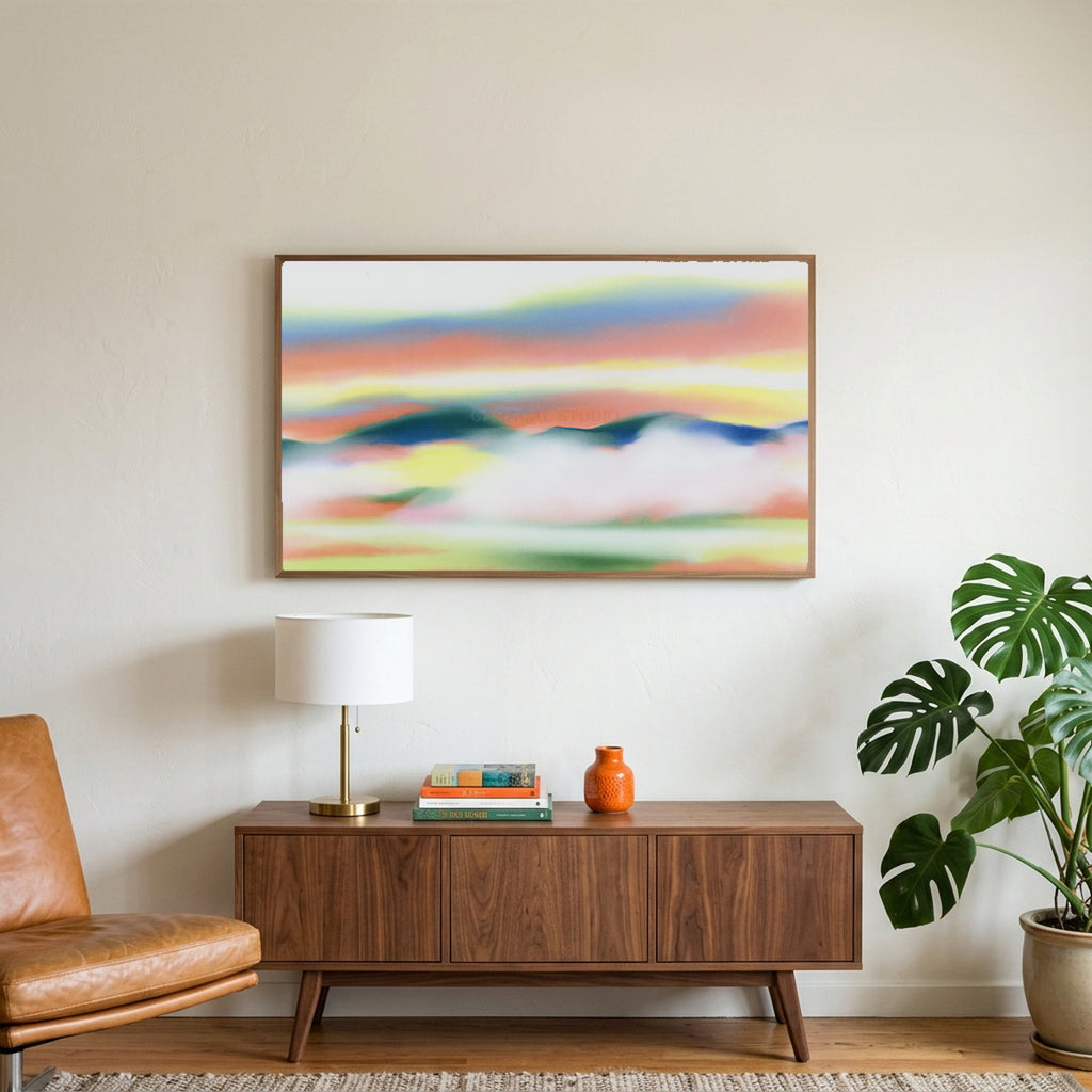 Abstract sunset hills art on a TV above a walnut credenza with a brass lamp and a monstera plant