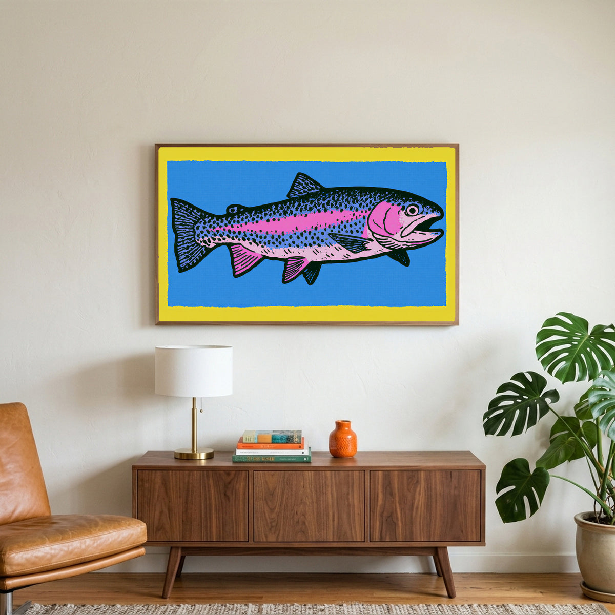 Rainbow trout art on a TV above a walnut credenza with a brass lamp and a monstera plant