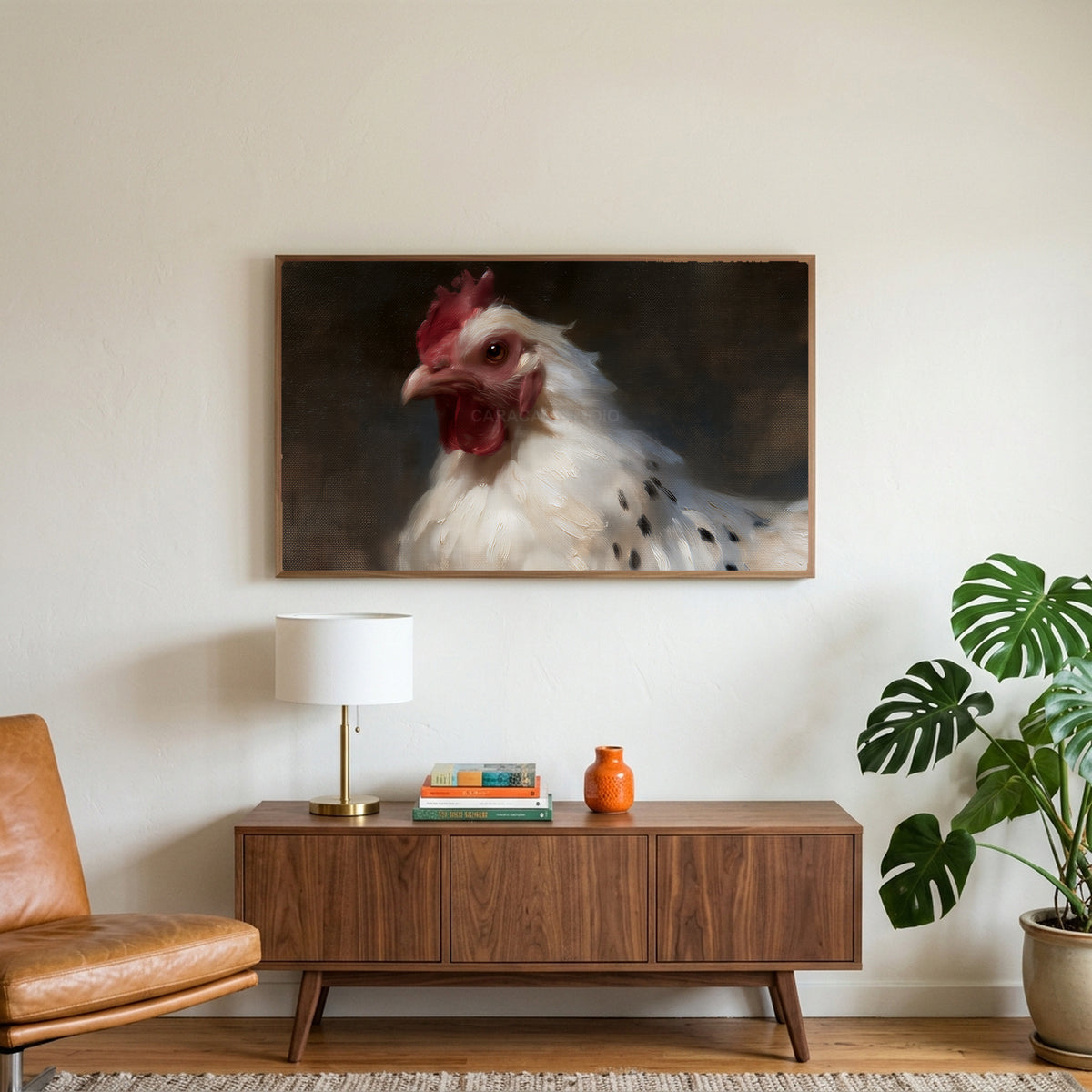 White hen portrait art on a TV above a walnut credenza with a brass lamp and a monstera plant