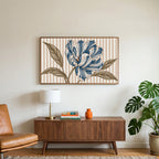 Striped tulip art on a TV above a walnut credenza with a brass lamp and a monstera plant
