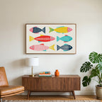 Linocut fish art on a TV above a walnut credenza with a brass lamp and a monstera plant