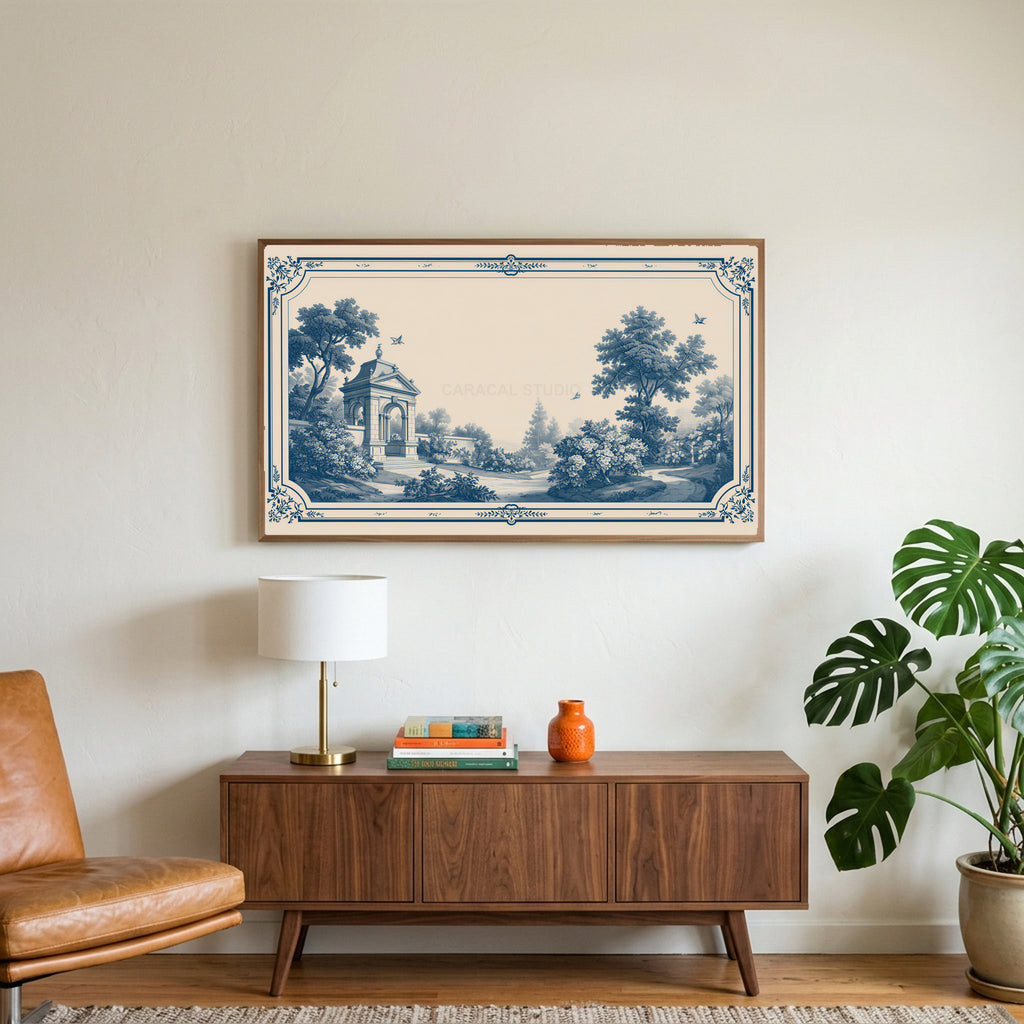 Blue toile garden art on a TV above a walnut credenza with a brass lamp and a monstera plant