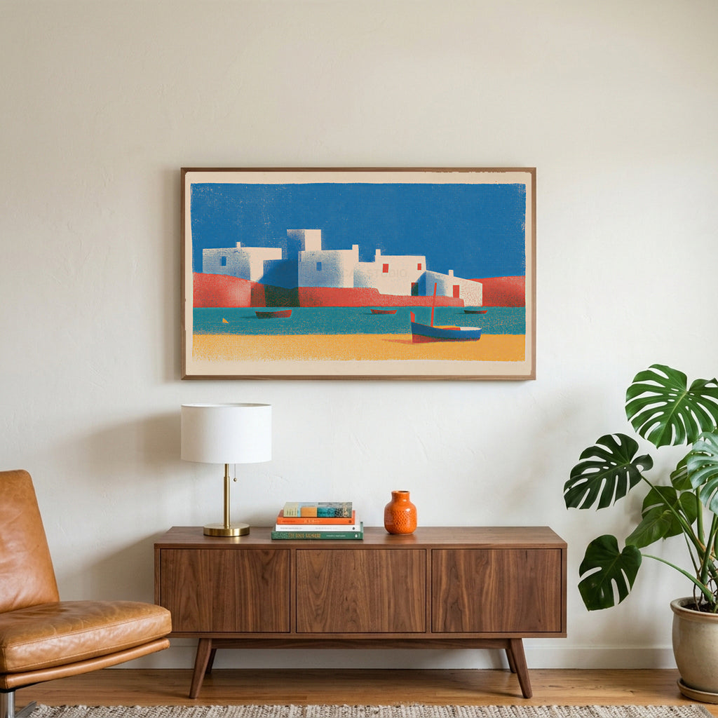 Mediterranean village art on a TV above a walnut credenza with a brass lamp and a monstera plant